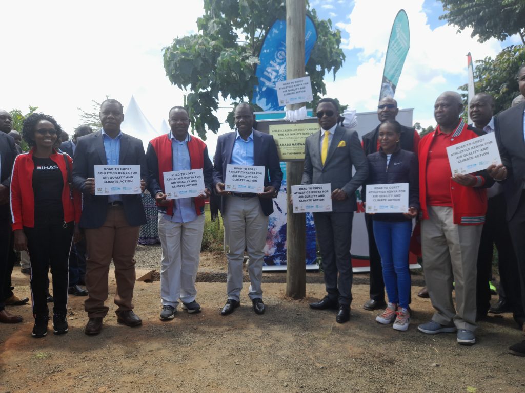 CS SPORTS ABABU NAMWAMBA AND GOVERNOR JONATHAN BII IN A PHOTO SESSION WITH ATHLETES AND AK OFFICIALS DURING THE INSTALLATION OF AIR QUALITY SENSOR AT LOBO VILLAGE ,ELDORET.